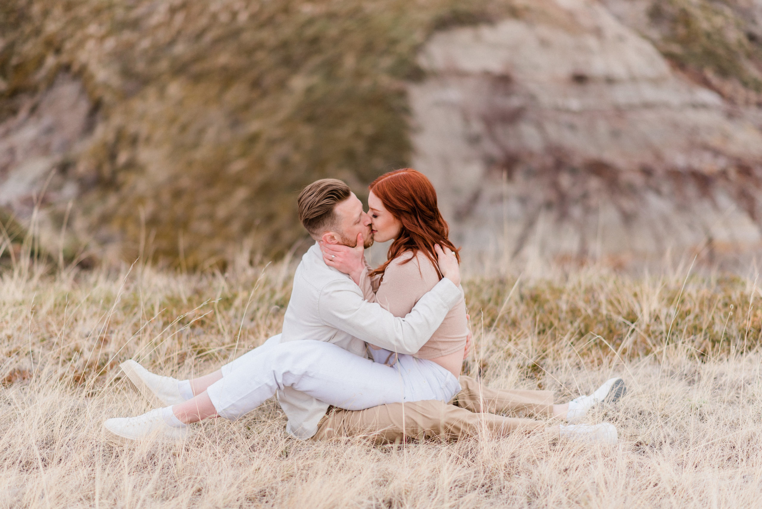 Couple embraces during their photo engagement session in Drumheller, Alberta.